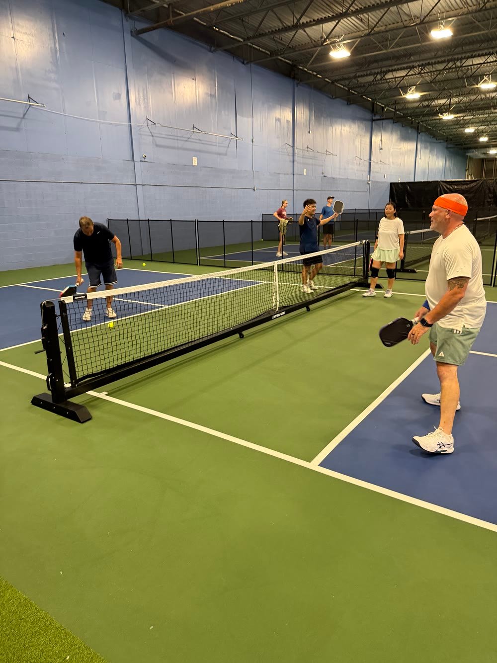 Doubles players trading shots at the net